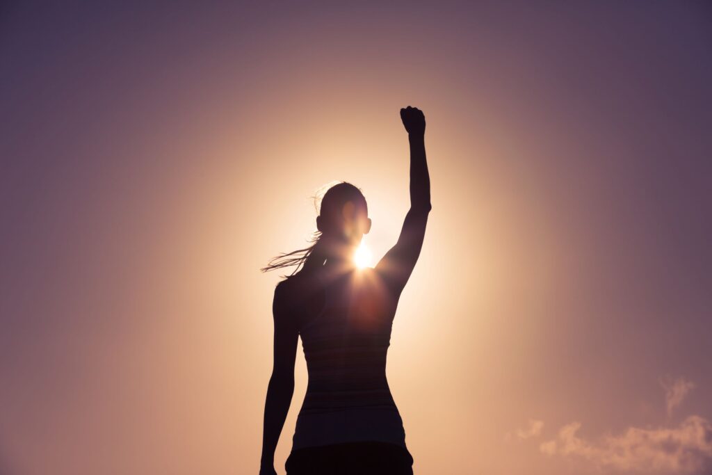 A woman raises her fist in the air.